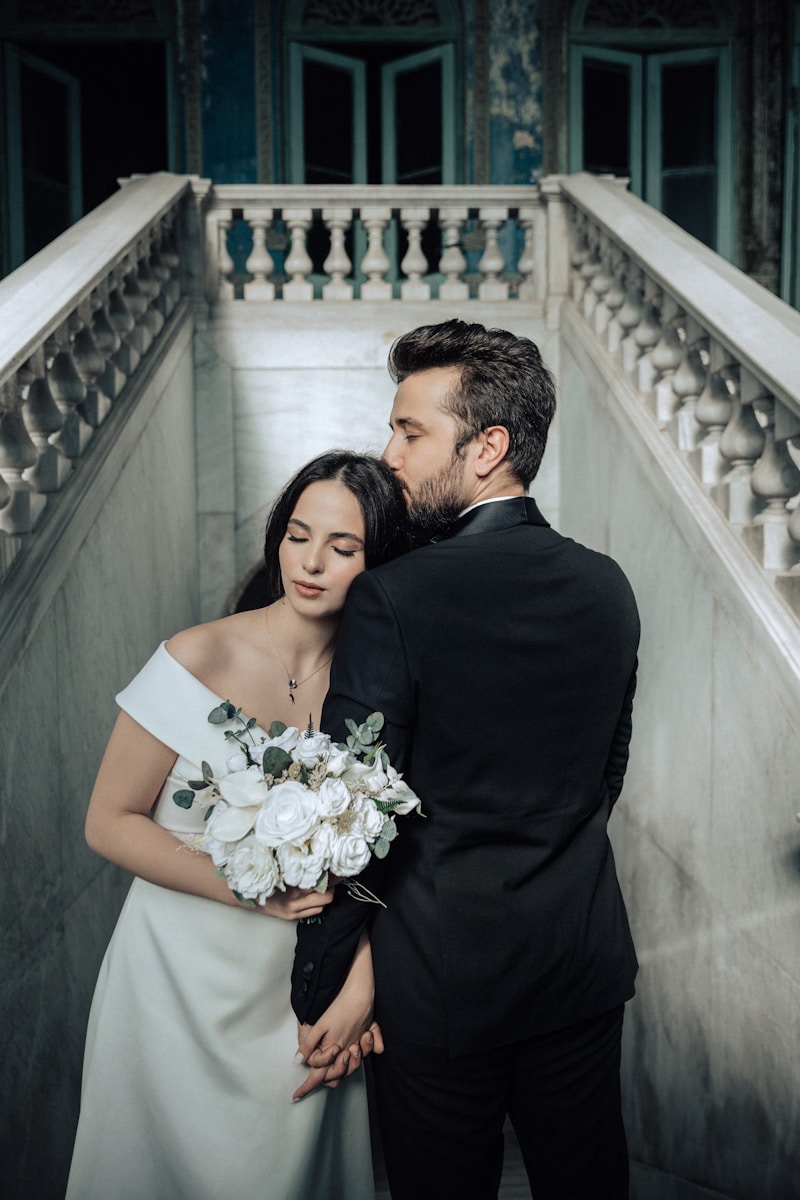 A bride and groom standing on a staircase — Thalam Studio wedding photography.